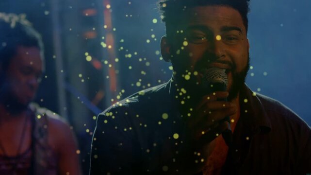 Vocalist starting singing in music club holding mic particles drifting over singer musician playing