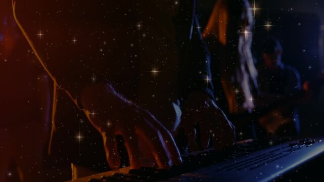 Camera shifting and zooming, keyboardist's hands pressing keys under star overlay, band performing