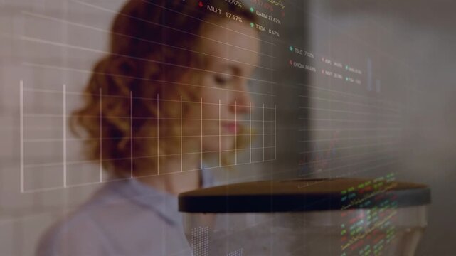 Cam pulling focus toward woman, sparking stock charts across face over hopper as she studying sales