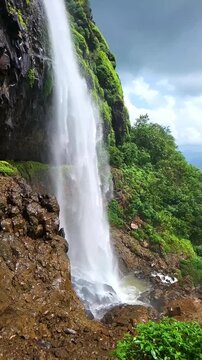 Laxmi Waterfall in stunning vertical slow motion, cascading gracefully through lush Sahyadri cliffs. Every drop captures the raw beauty and calm power of the monsoon season.