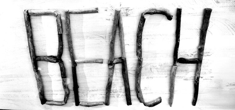 Beach is spelled Out With Pieces of Driftwood