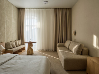 Fototapeta premium Modern and Cozy Hotel Bedroom Interior with Warm Lighting 