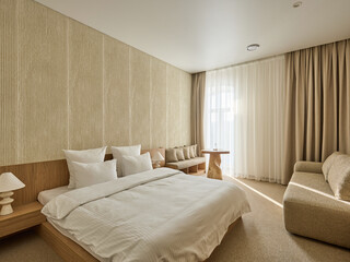 Fototapeta premium Modern and Cozy Hotel Bedroom Interior with Warm Lighting 