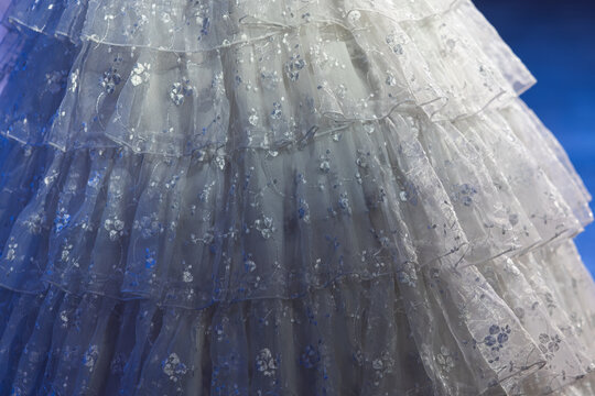 White tiered lace dress with floral embroidery close-up