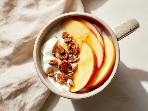 Healthy breakfast with creamy yogurt fresh peach slices and walnuts drizzled with honey for a nutritious morning meal concept