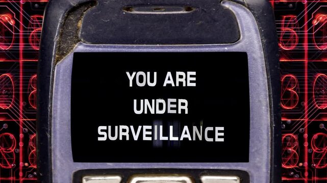 retro and old mobile telephone with you are under surveillance