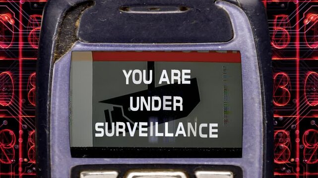 retro and old mobile telephone with you are under surveillance