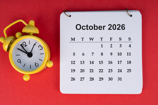 October 2026 desk calendar on red background