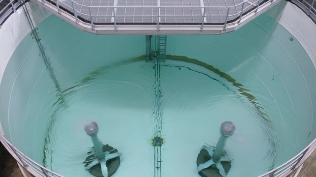 Industrial Mixing Tank with Agitators and Water.