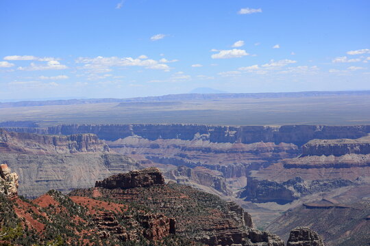 Layered Canyon Cliffs with Deep Valley and Expansive Desert Horizon