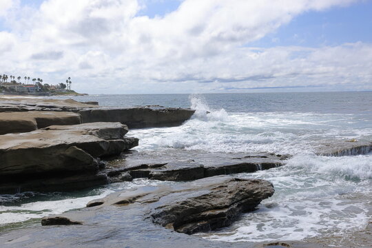 Ocean Waves Crashing Against Coastal Rock Formation with Sea Spray