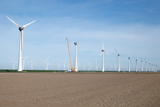 Wind turbine installation in polder landscape Netherlands