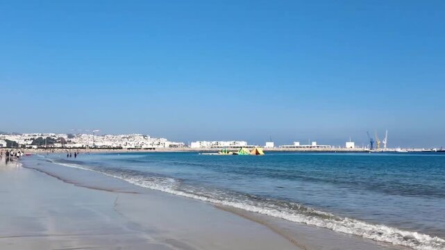 Tangier Beach Morocco with Ocean Waves and City Coastline Summer Lifestyle Pan Scene