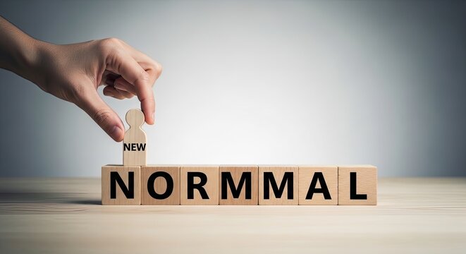 The concept of normalcy hand adjusting wooden blocks with 'normal' inscription