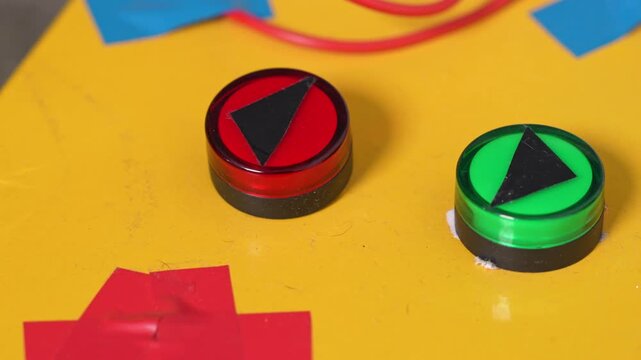 A dog presses a red button on a bright yellow surface with colorful geometric shape, time machine concept, funny creative pet scen