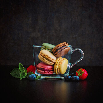 Macaroons with berries in a glass cup