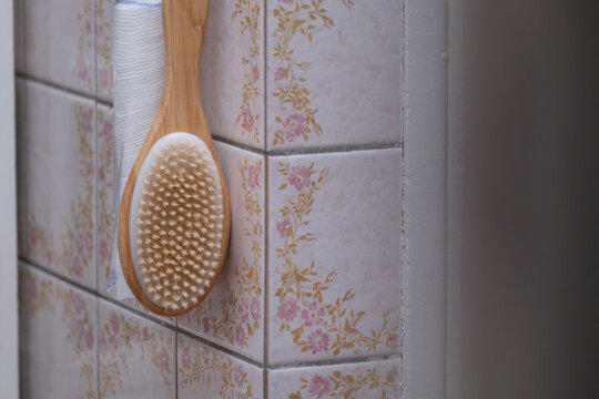 Wooden Body Brush Hanging in Old Bathroom Interior Close Up Hygiene Concept