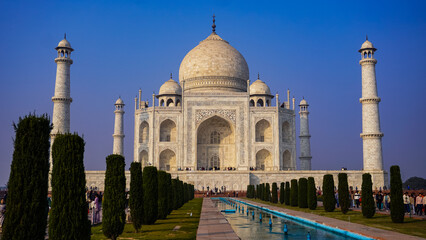Naklejka premium The Taj Mahal at sunrise with reflections in the garden water channel, Agra, Uttar Pradesh, India