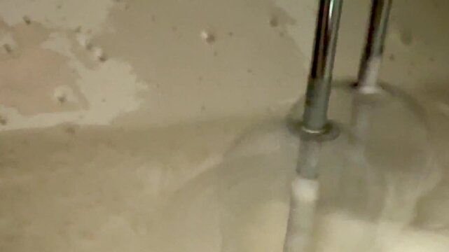 A close-up shot of a mixer whipping fresh white cream. Cooking delicious food at home.