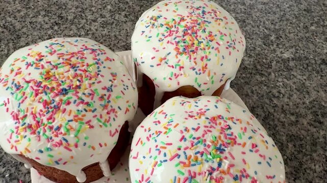 Easter cakes with white icing and sprinkles. A traditional homemade Easter pastry.
