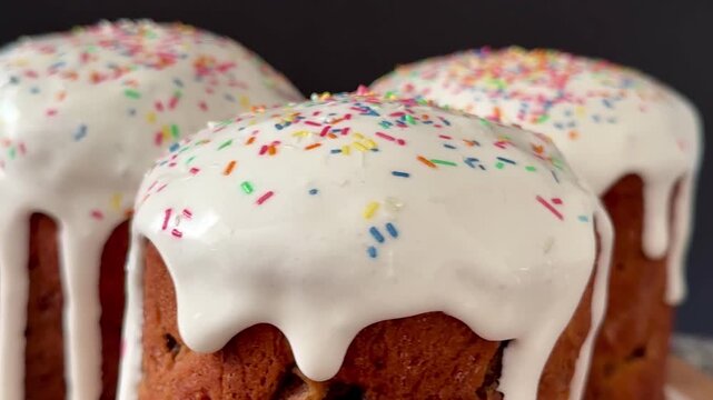 Easter cakes with white icing and sprinkles. A traditional homemade Easter pastry.