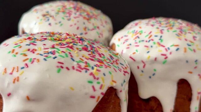 Easter cakes with white icing and sprinkles. A traditional homemade Easter pastry.