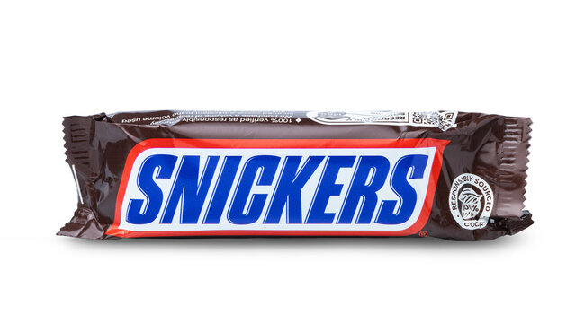 KYIV, UKRAINE - April 01, 2026: Chocolate snickers bar in the package isolated on white.