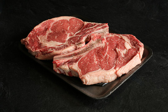 Fresh rip eyed steak on a black background.