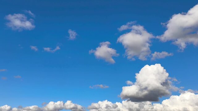 Spacious and blue sky with grey clouds moving and growing