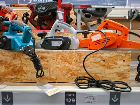 VORONEZH, Russia - April 8, 2026.Electric hand planers on display at a tool shop in Russia with various colors and brands presented clearly on wooden blocks