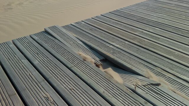 Old wood surface. Sunlit weathered wood with cracked slats and subtle coastal ambiance in high definition