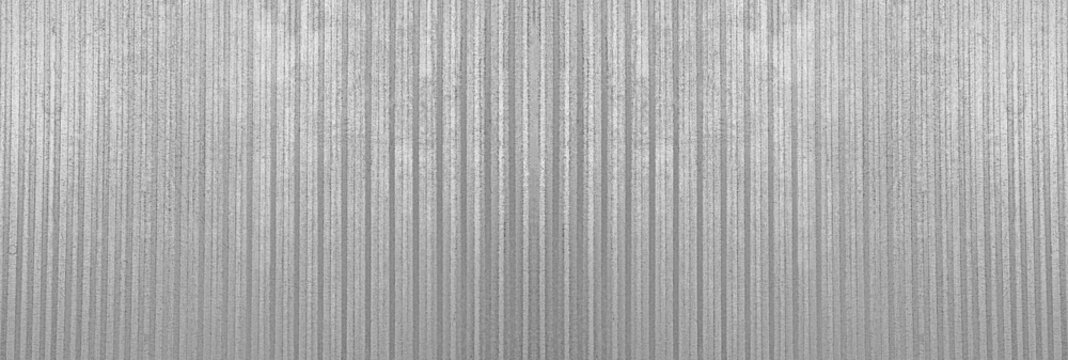 Silver tin iron corrugated wall with horizontal stripes from a metal profile of metal sheet Texture, background. grey white wall fence texture for backdrop galvanized gray facade.