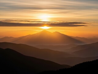 Obraz premium Majestic mountain sunrise with golden sun rays, atmospheric mountain peaks at dawn, scenic wilderness landscape with orange glowing sky