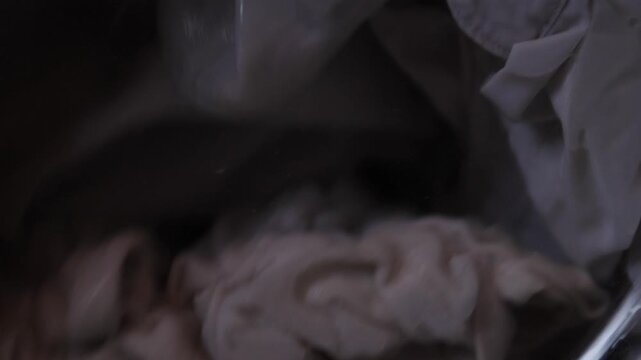 Wet Shirt And Fabrics Wrinkling Inside Drum Under Agitation Parent Or Stylist Watching Wrinkle Patterns As Machine Spins, Texture And Seams Visible With Close Detail And Motion Blur.