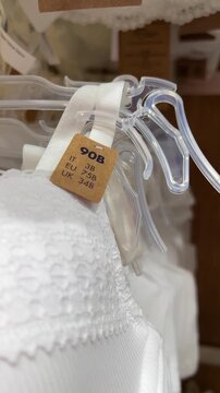 Vertical video close up. White bra with tag with 90 B sign. EU, RU, IT size. Concept of buying female casual clothes in retail store, Black Friday sale, 11 november, shop, discount, retail, fashion