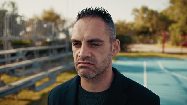 man with a sad expression outdoors