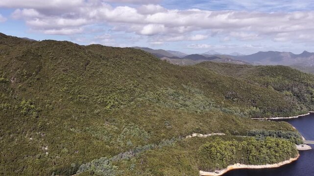 Mounts and vale around Burbury lake of Tasmania in aerial scenic panorama.