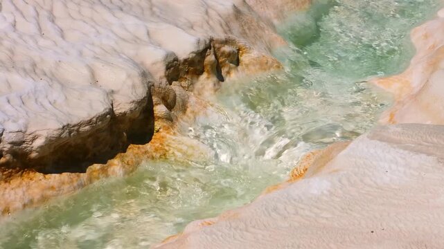 Pamukkale, a UNESCO World Heritage site in Turkey, features stunning natural white terraces formed by mineral-rich hot springs depositing carbonate minerals over millennia.