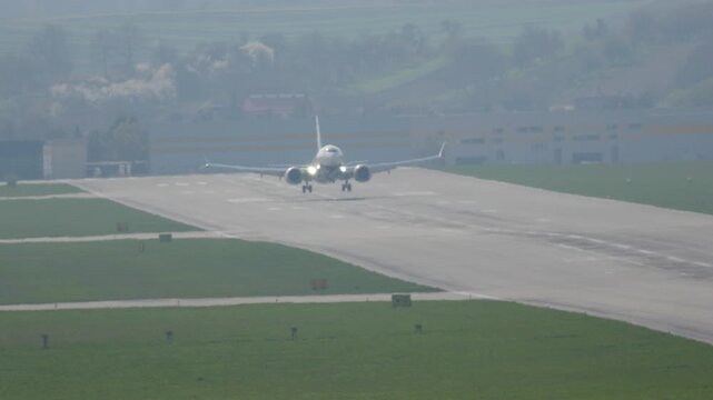 Passenger aircraft gracefully lands on runway, completing a beautiful journey to its destination with a smooth touchdown moment