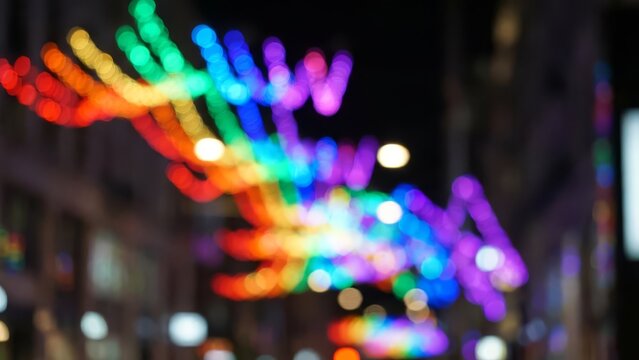 Vibrant Bokeh Rainbow Lights Decorate Night Cityscape with Celebrating Pride.