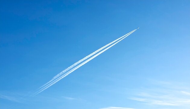 Jet Plane with Contrail Flying Across Clear Blue Sky
