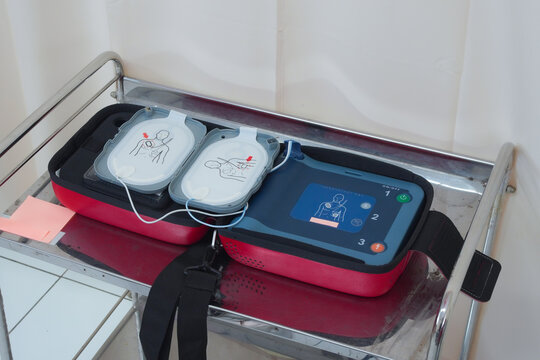 Automated External Defibrillator (AED) with pads on a medical cart