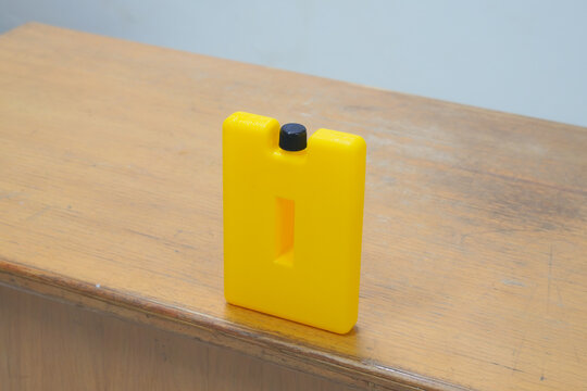 Yellow Ice Pack Ice Bags for therapy on wooden table