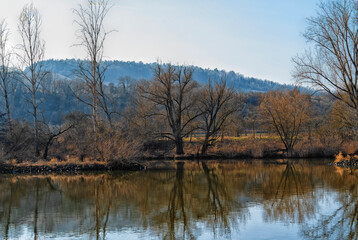 Fototapeta premium River, trees, hills on the horizon, spring landscape