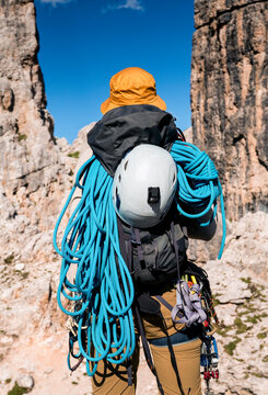 A young athlete man prepares for climbing, mountaineering outdoors.