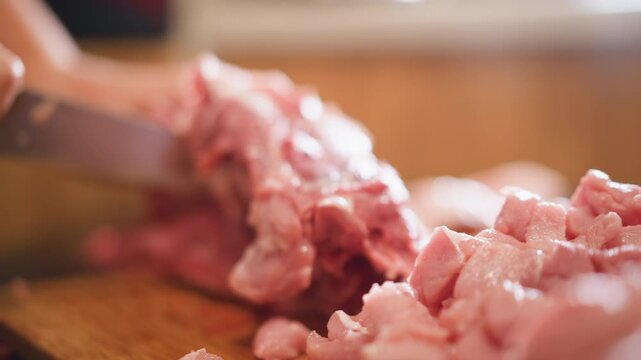 Home cook lifting rib slab from cutting board, raw pork bones and marbling visible, cleaver action and boning movement, butcherystyle prep for roast, rustic kitchen light and weekend meal focus