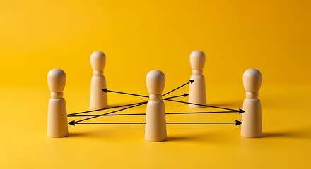 Obraz premium Wooden figures connected by arrows on a vibrant yellow background, symbolizing communication