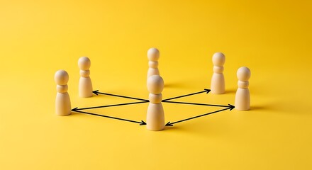 Obraz premium Wooden figurines with connecting arrows on yellow background, symbolizing teamwork
