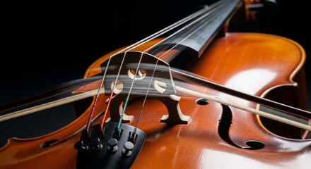 Fototapeta premium A dramatic close-up of a wooden cello in a dark, minimalist setting with artistic motion blur capturing the vibration of the strings, cinematic, background, sound