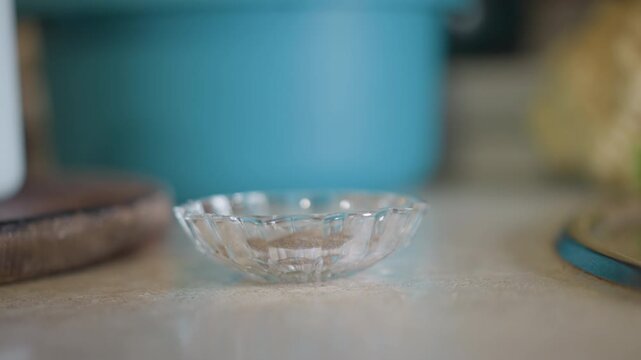 Calm scene with glass dish. Serene home kitchen environment with dish waiting for ingredients. Elegant and peaceful kitchen setting featuring empty glass container under soft natural lighting